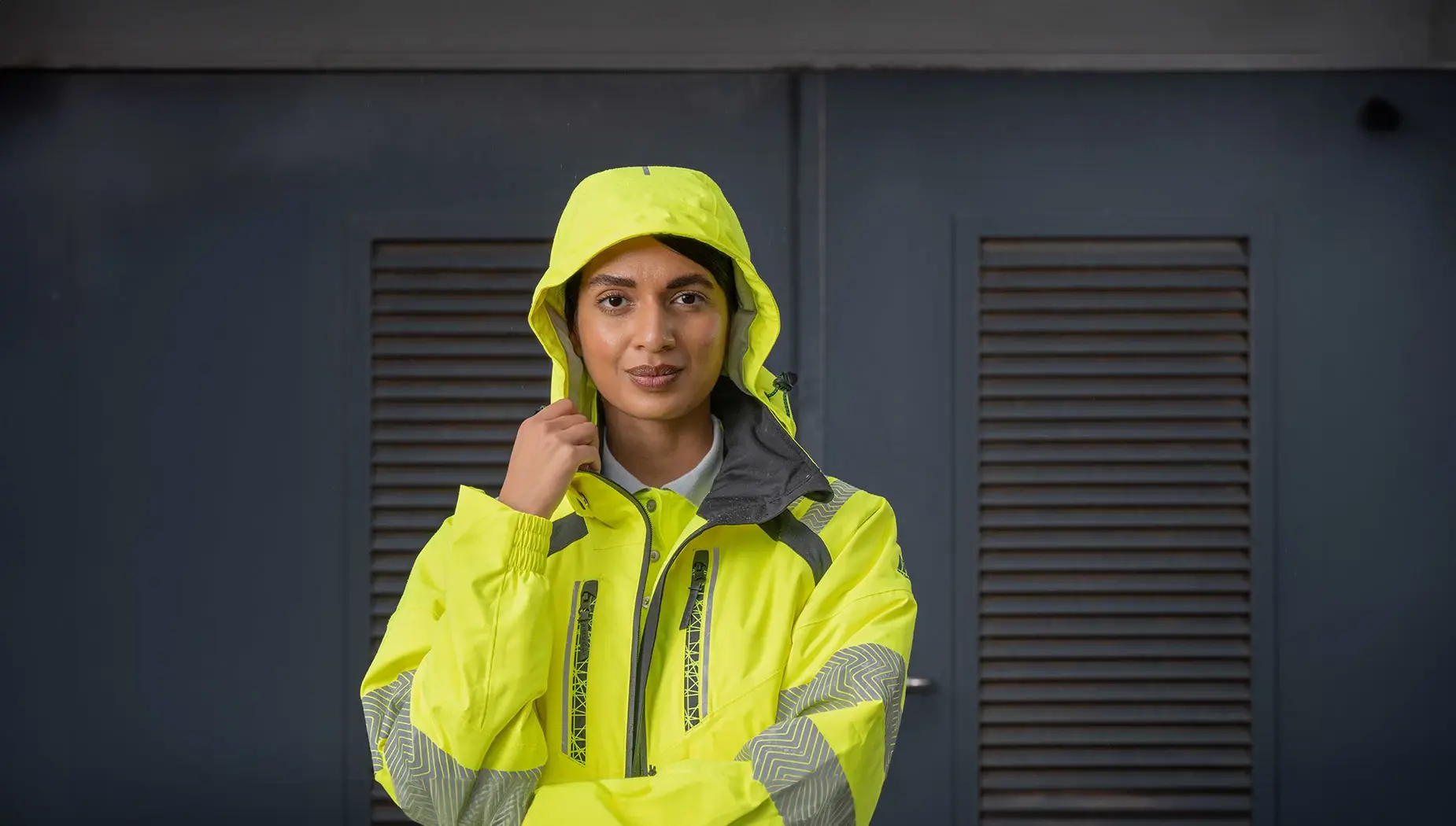 model wears a high-visibility waterproof parka in yellow from PULSAR®