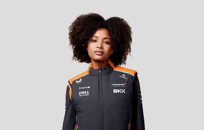 A female model wearing F1 teamwear jacket